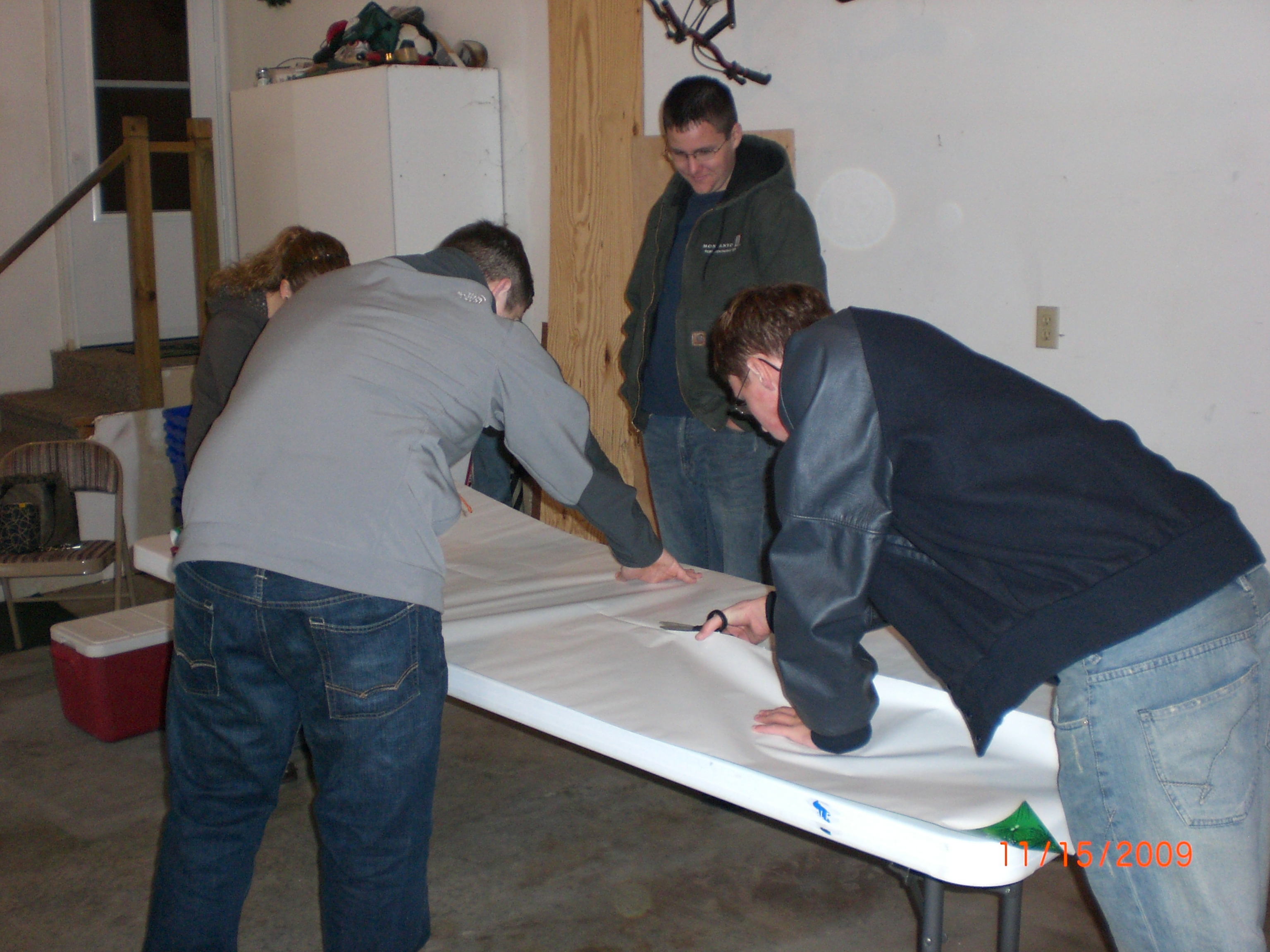 Teenage boys cutting wrapping paper